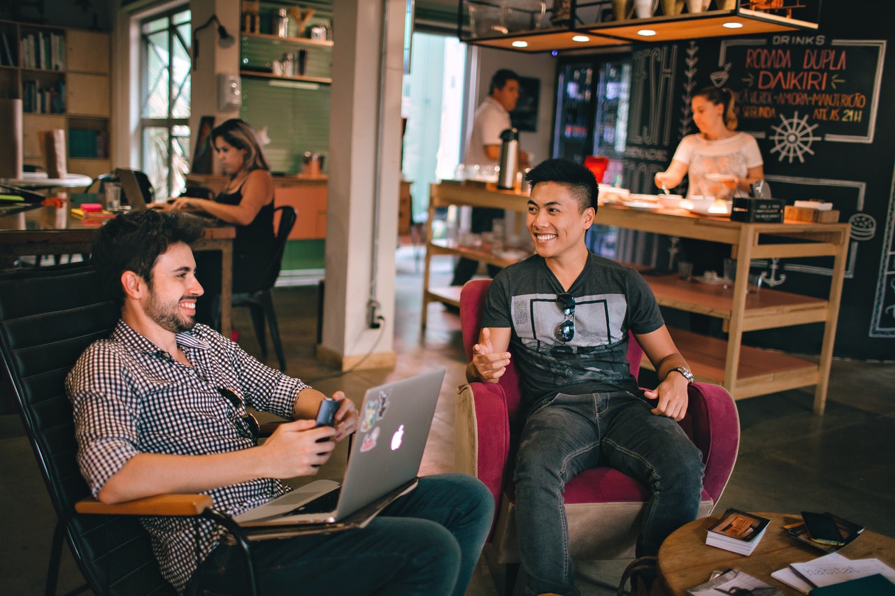 men having conversation sitting in a coffee shop