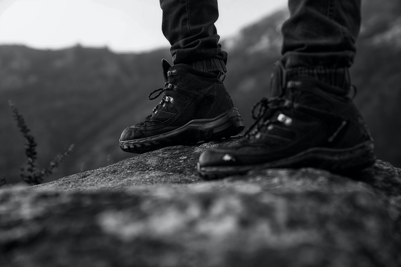 person wearing black boots standing firm