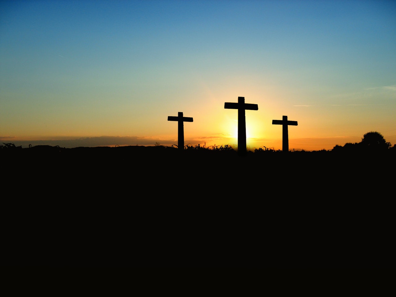 Silhouette of 3 crosses under the blue sky