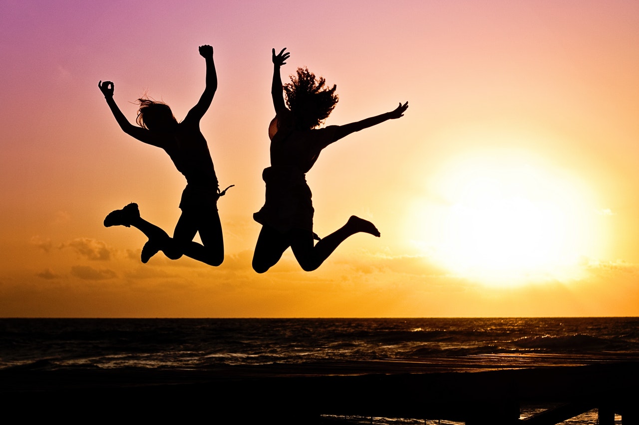 People jumping with joy at the beach